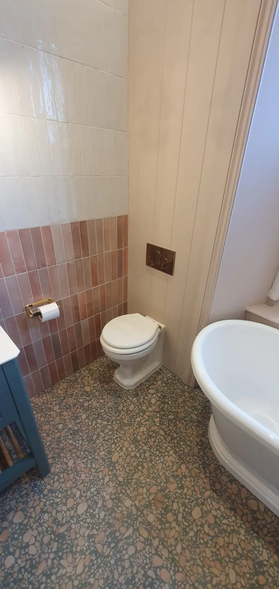 Newly fitted bathroom with a wall-mounted toilet and freestanding bath