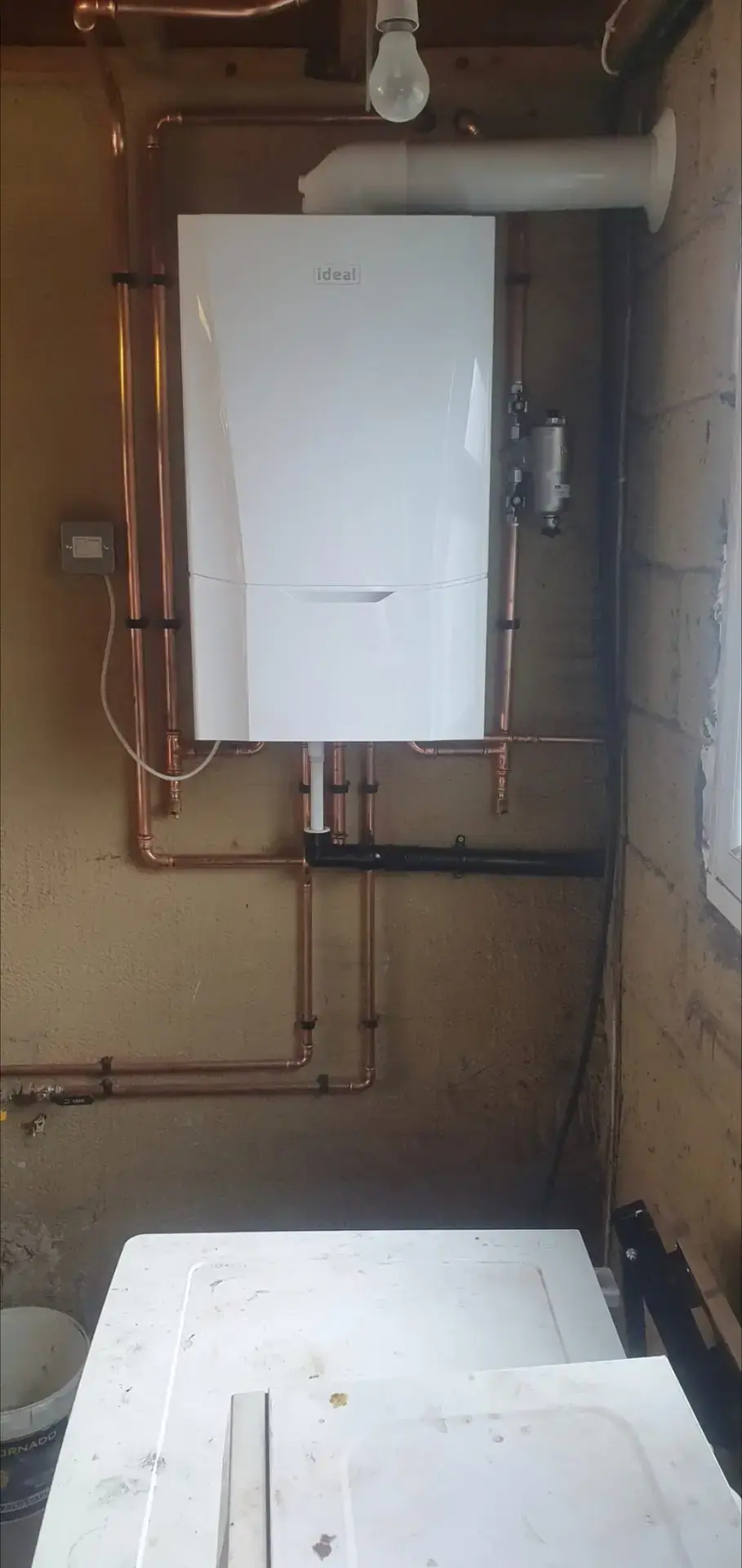Ideal boiler fitted by EFW Gas, with neat copper pipework running down the wall